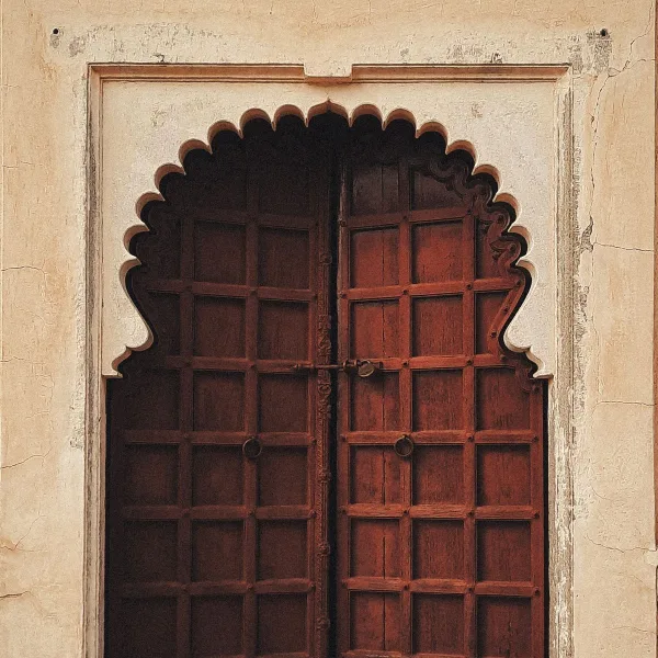 Carved arched wooden door set in a Rajasthani facade